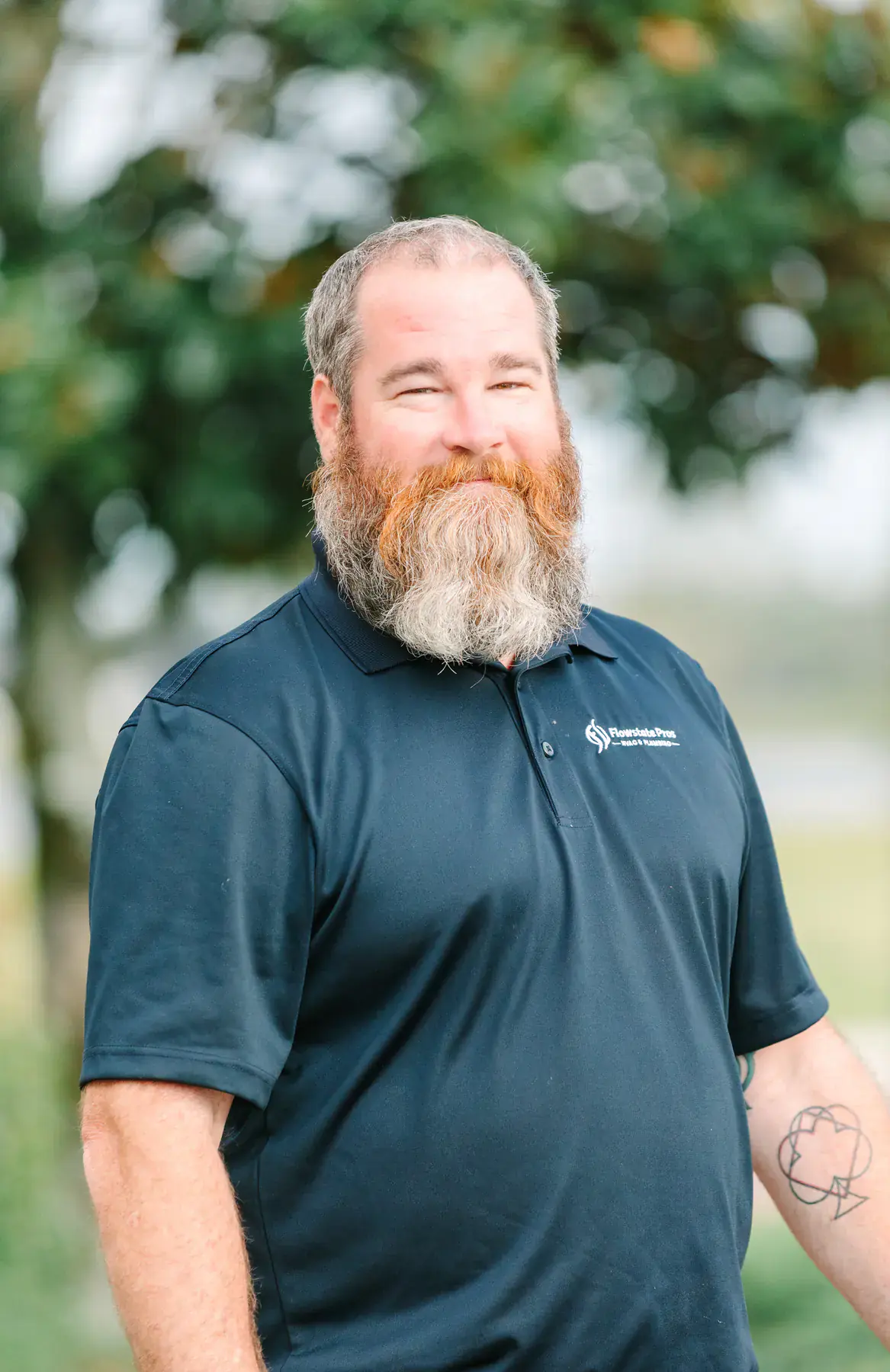 Erick Rose, Lead Master Plumber at Flowstate Pros, in a Flowstate Pros polo shirt